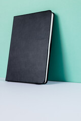Close up of black notebook with copy space on green background
