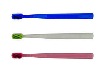 New toothbrushes - red, white and blue - isolated - top view