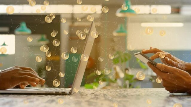 Animation of multiple bitcoin symbols against mid section of man and woman using electronic devices