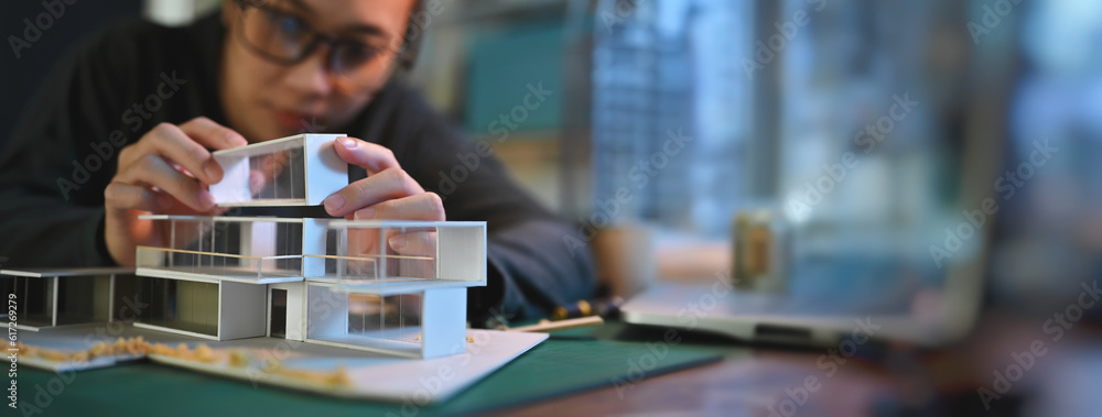 Poster architecture students diligently make house model building samples with paper architecture and tools