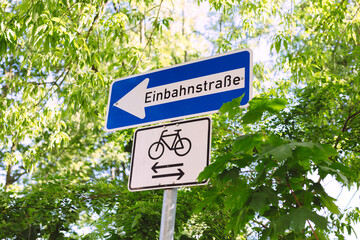 One-way street sign and cyclist free sign