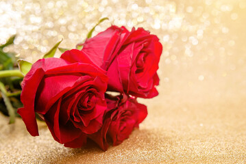 Red rose on a shiny gold background
