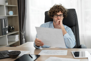 Caucasian businessman working with paper work in office