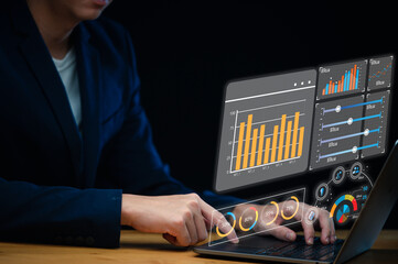 Investing in the stock market. Finance and banking technology, businessman analyzing economic growth graph, financial data on laptop, business strategy and digital marketing concept.