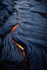 Obraz premium Aerial view, black rock striation with lava veins, vibrant raking light Generative AI