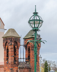 old vintage street lamp near the red brick architectural elements 
