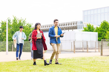 Multinational youth group walking in outdoor facility.