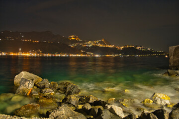 Fototapeta premium View of Taormina at night from the port of Giardini Naxos, Sicily, Italy