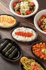 Mixed Turkish appetizers on wooden table. Turkish Mezze. such as stuffed leaves, humus