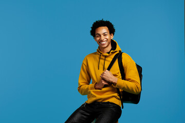 young adult college student with backpack smiling