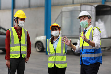 Group of technician engineer and businessman in protective uniform standing and discussing, researching, brainstorming and planning work together with protection mask at industry manufacturing factory
