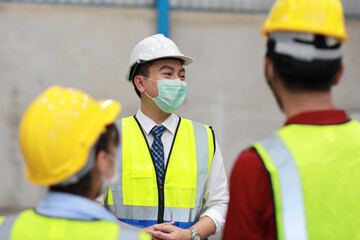 Group of technician engineer and businessman in protective uniform standing and discussing, researching, brainstorming and planning work together with protection mask at industry manufacturing factory