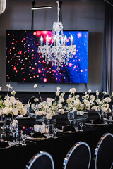 Banquet decoration composition flowers, candles, candlesticks in hall restaurant. Luxury wedding...