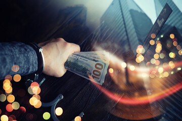  Double exposure city and hands of a man with handcuffs on a background of us dollars. Fraud, cyber...