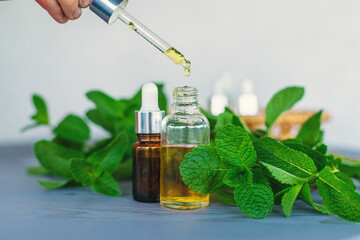 Peppermint essential oil in a bottle. Selective focus.