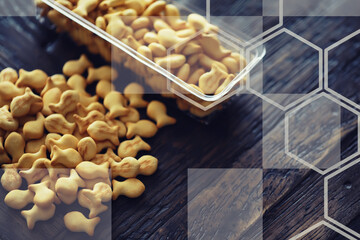 Closeup view of fish shaped salted crackers. Small tasty biscuits. Fish shaped cookies background.