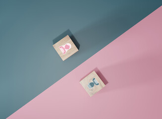 Male and female sex icons on wooden cubes on pink and blue background. Sex change, gender...