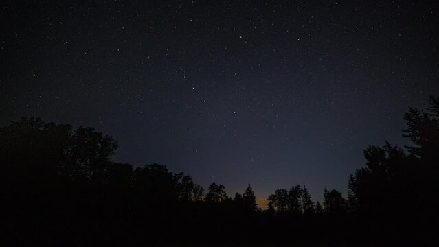 Nigh sky time lapse with summer sky over forest.