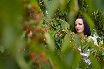 Beautiful woman eating cherry berries for fun