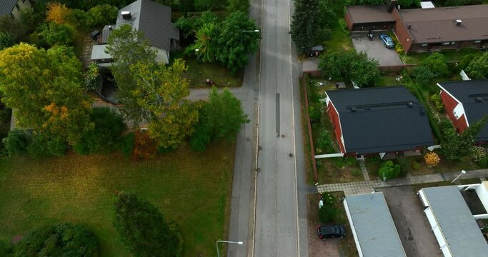 Aerial view tilting over a road in middle of the suburbs of north Helsinki, fall in Finland