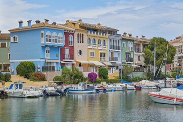 Panoramic view of colorfull houses and moored yachts in Port Saplaya