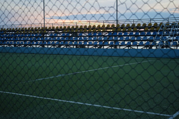 View of a children's soccer field. Green lawn of football field. Football field. artificial grass. Spring time. Batumi, Georgia. white lines. stadium with many seats.