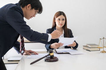 Judge gavel with Justice lawyers having team meeting at law firm background. Concepts of Law and Legal services.