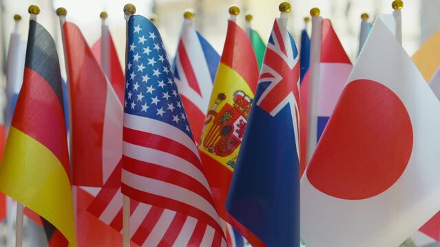 Row of international flags close-up. Closeup countries national symbols fluttering in wind on sunny day