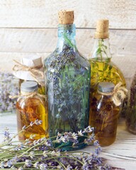 Lavender flowers, tincture bottles and lavender oil jars, on wooden background, natural ingredients, alternative medicine