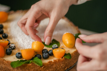 Cheesecake with citrus and berries is prepared in the kitchen