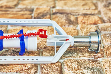 Plumbing. Toilet flush mechanism, siphon fittings on brown checkered pvc