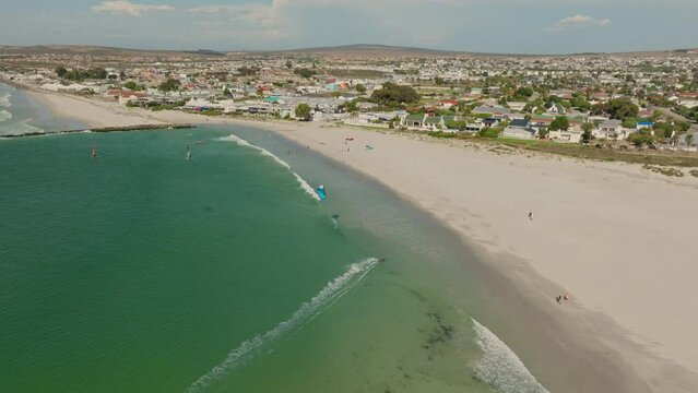Drone shot of a kitesurfer during mid day, in the background the town of Langebaan.
