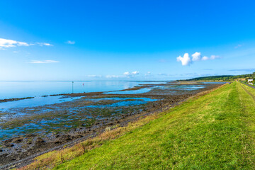 View, during a beautiful sunny day, from the dike on the south side of the island of Vlieland on a partly dried up Wadden Sea