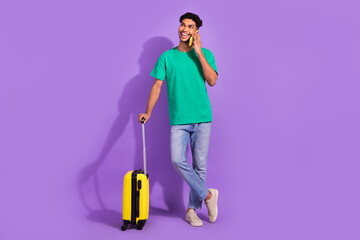 Full body photo of handsome man speak telephone hold suitcase isolated on violet color background