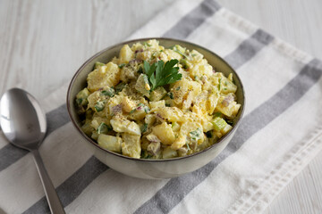 Homemade Potato Egg Salad with Pickles in a Bowl, side view.