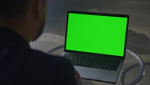 Over The Shoulder View on Green Screen Laptop