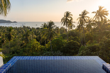 Tropical island pool villa resort with sea view on palm trees and sea horizon from the high on Koh Tao island in Thailand