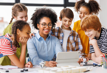 Teacher and students watching tablet screen