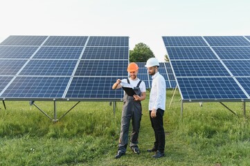 engineer and businessman planing new ecology project. around solar panel roof