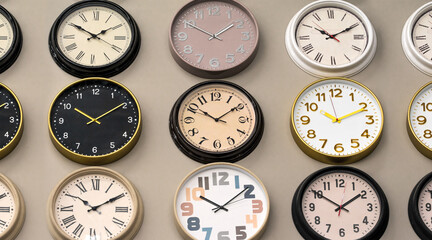 Collection of different clocks on the wall. Analog vintage clocks, electronic and mechanical watch faces with numbers and clock hands. Classic watch accessories.