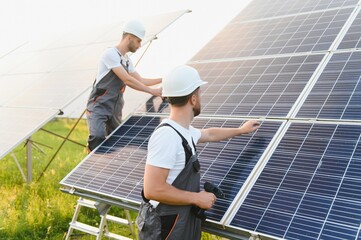 Engineering team working on checking and maintenance in solar power plant, Solar panel technician...