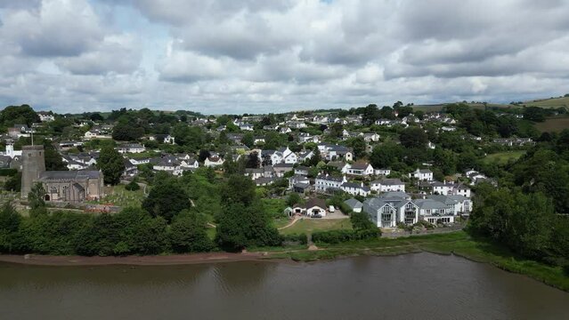 Stoke Gabriel, South Devon, England: DRONE AERIAL VIEWS: The drone tracks right-to-left over the Mill Pond showing the riverside properties of Stoke Gabriel village and St Mary & St Gabriel church.
