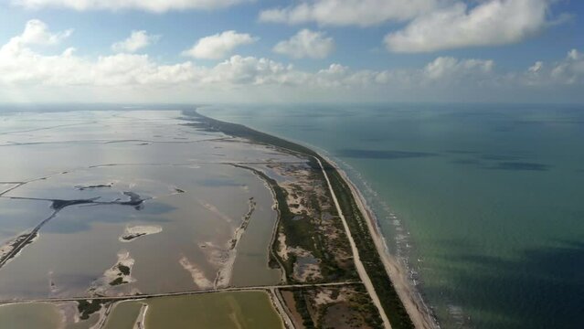 Archipelago with islets and narrow isthmus with road in Caribbean sea.