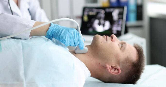 Man examine thyroid gland with ultrasound probe in medical office. Thyroid disease in man concept