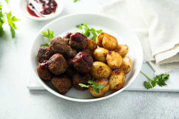 Homemade veal meatballs with potato and berry sauce