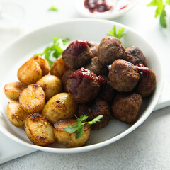 Homemade veal meatballs with potato and berry sauce