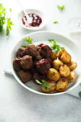 Homemade veal meatballs with potato and berry sauce