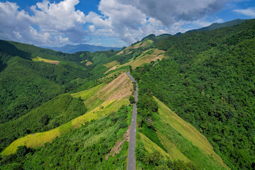 Fototapeta na wymiar Aerial view of Beautiful blue sky and road over top of mountains, Nan province, Thailand.