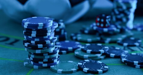 Image of several red dice falling on green table on background of multicolored spots