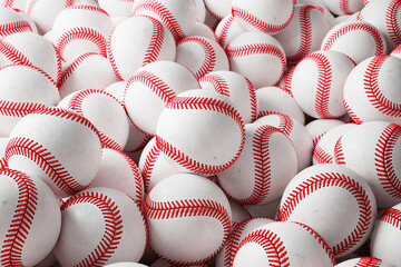 A large number of white baseball balls. Set of many professional sports balls.
